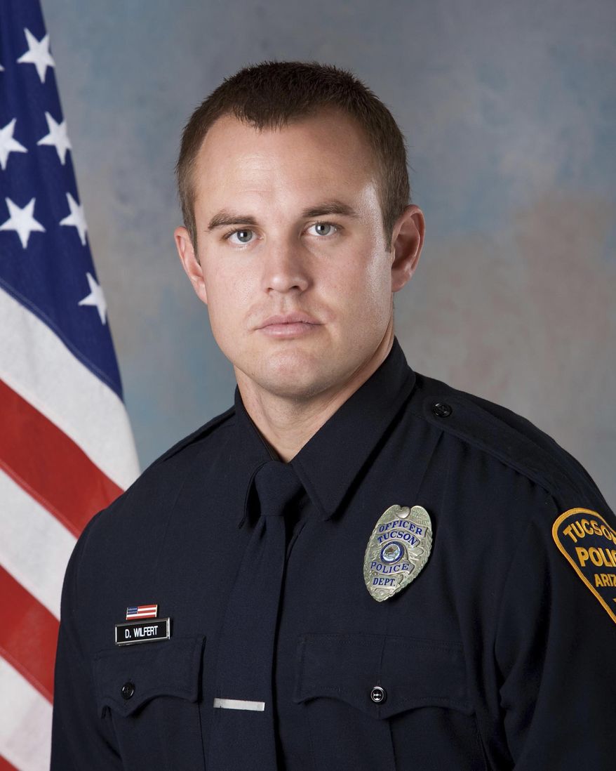 In this undated photo provided by the Tucson Police Department shows police officer Doug Wilfert, one of two police officers wounded Thursday morning, Dec. 1, 2016, as they sought to take Jose N. Barron Gomez into custody on a felony arrest warrant for aggravated assault with a dangerous instrument. Gomez, 27, was killed in the shooting. (Tucson Police Department via AP)