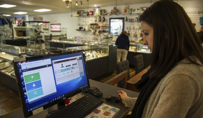 In this Wednesday, Nov. 23, 2016, file photo, Ashley Nicklaus, owner of the Pawn and Jewelry Exchange explains the Precious Metals Database, and how she uses that system and her personal jewelry tracking system by Bravo, to keep track of items coming into her pawn shop in Greensburg, Pa. (Dan Speicher/Pittsburgh Tribune-Review via AP) ** FILE **