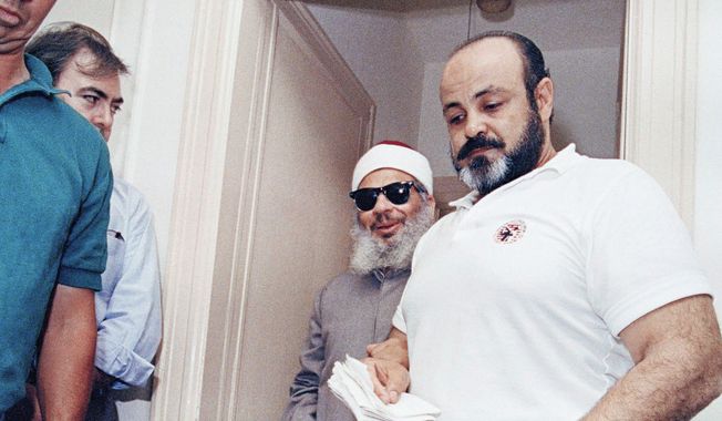 Emad Salem, 43, the confidential informant in an alleged bombing plot, June 17, 1993 in Jersey City, N.J. Escorting blind Muslim clericSheik Omar Abdul-Rahman at a news conference at the Sheik&#x27; s apartment In Jersey City . (AP Photo/Daniel Hulshizer)
