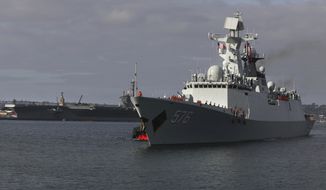 The Chinese Navy frigate Daqing 576 approaches the waterfront in San Diego, Calif., with a U.S. aircraft carrier on the North Island base in the background, Tuesday, Dec. 6, 2016. Three People&#x27;s Liberation Army (Navy) ships are visiting San Diego as part of a routine port visit, from Dec. 6-9. (Peggy Peattie/The San Diego Union-Tribune via AP)