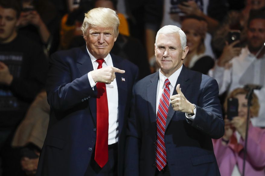 President-elect Donald Trump, left, and Vice President-elect Mike Pence acknowledge the crowd during the first stop of his post-election tour, in Cincinnati, Dec. 1, 2016. The Heritage Foundation says Pence will deliver a speech Tuesday night, Dec. 6, 2016, to a conservative group at Trumps new hotel in Washington, about areas of focus for the Trump administration in the first 200 days. (AP Photo/John Minchillo, File) ** FILE **