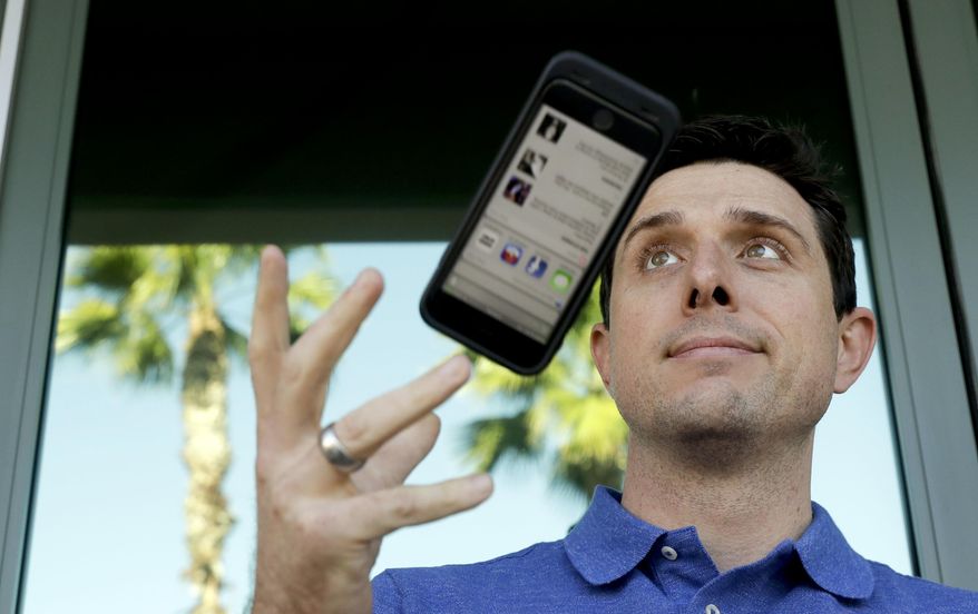 In this Wednesday, Nov. 30, 2016, photo, Aaron Norris poses for a picture with his smartphone near his office, in Riverside, Calif. Norris finds it's a struggle to let go of his electronic devices and the temptation to keep reading work email during his off hours. (AP Photo/Chris Carlson)