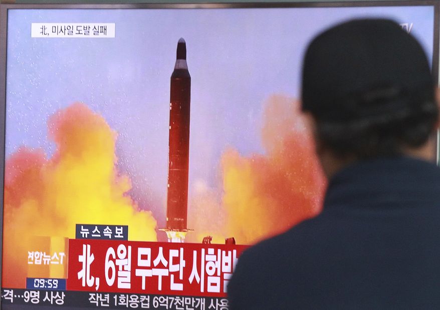 FILE - In this Oct. 16, 2016, file photo, a man watches a TV news program showing a file image of a missile launch conducted by North Korea, at the Seoul Railway Station in Seoul, South Korea. North Korea now has the capability to launch a nuclear weapon, a senior U.S. military official said Dec. 8, adding that while the U.S. believes Pyongyang can mount a warhead on a missile, it's not clear that it can hit a target. (AP Photo/Ahn Young-joon, File)