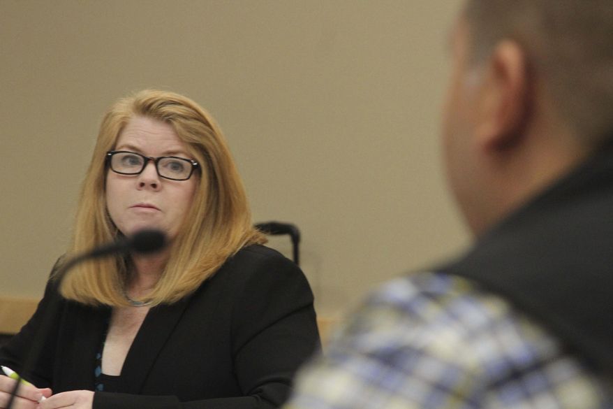 FILE - In this Sept. 7, 2016 file photo, Alaska Marijuana Control Office Director Cynthia Franklin, left, listens as the agency's chief enforcement officer, James Hoelscher, testifies before the Alaska Marijuana Control Board during a meeting in Anchorage, Alaska. Franklin, who helped guide Alaska's work in setting up the state's legal marijuana industry, is resigning as director of the Alcohol and Marijuana Control Office. (AP Photo/Mark Thiessen, File)