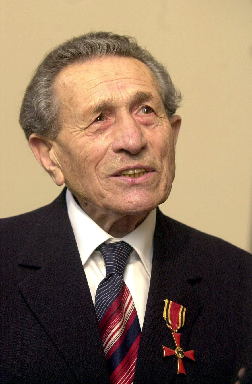 - FILE - In this Oct. 10, 2001 file picture Adolf Burger, a Jewish typographer who was forced by the Nazis to make fake British pounds in a major counterfeit operation during World War II, listens during ceremony at the German Embassy in Prague after he was awarded with the Order of Merit. Public broadcaster Czech Radio, citing Burger's family, reported on Thursday, Dec. 8, that the Holocaust survivor died on Tuesday in Prague. (Michal Kamaryt/CTK via AP)