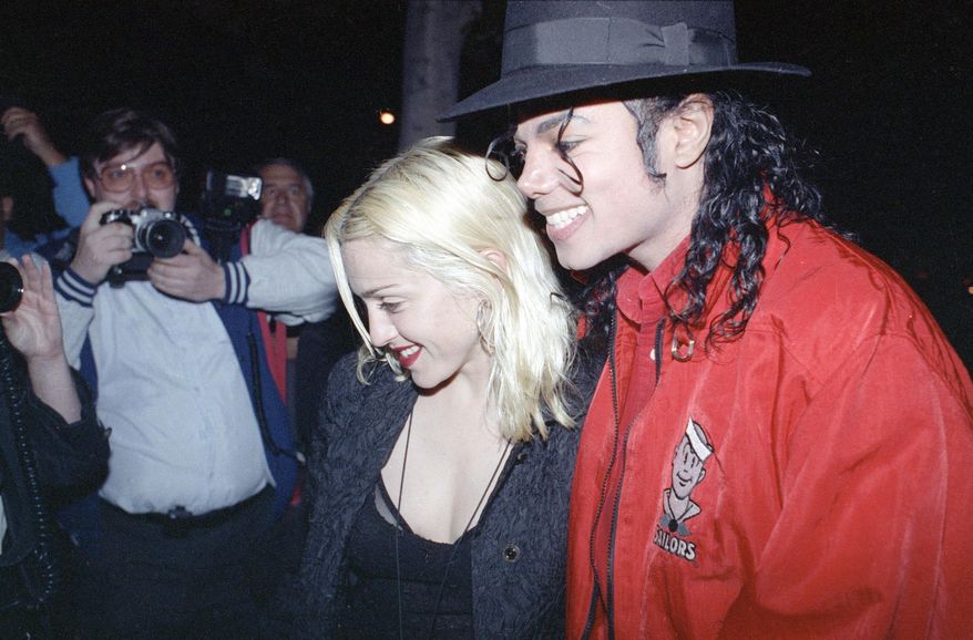 FILE - In this April 10, 1991, file photo, Madonna and Michael Jackson go out for dinner together at a restaurant in Los Angeles. Madonna told CBS' James Corden in an appearance on "The Late Late Show," Wednesday, Dec. 7, 2016, that she made out with Jackson once after giving him a glass of win. (AP Photo/Kevork Djansezian, File)