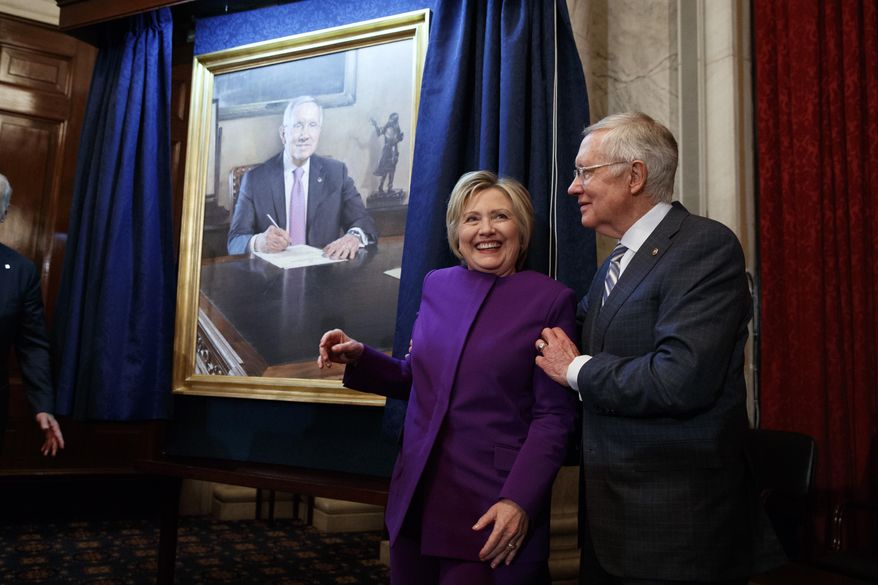 Former Secretary of State Hillary Clinton, left, smiles as Senate Minority Leader Sen. Harry Reid, D-Nev., poses her for a photograph during a ceremony to unveil a portrait of Reid, on Capitol Hill, Thursday, Dec. 8, 2016, in Washington. (AP Photo/Evan Vucci)