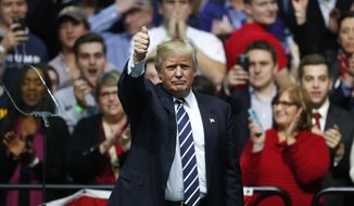 President-elect Donald Trump gives a thumbs up to supporters during a rally in Grand Rapids, Mich., Friday, Dec. 9, 2016. (AP Photo/Paul Sancya)
