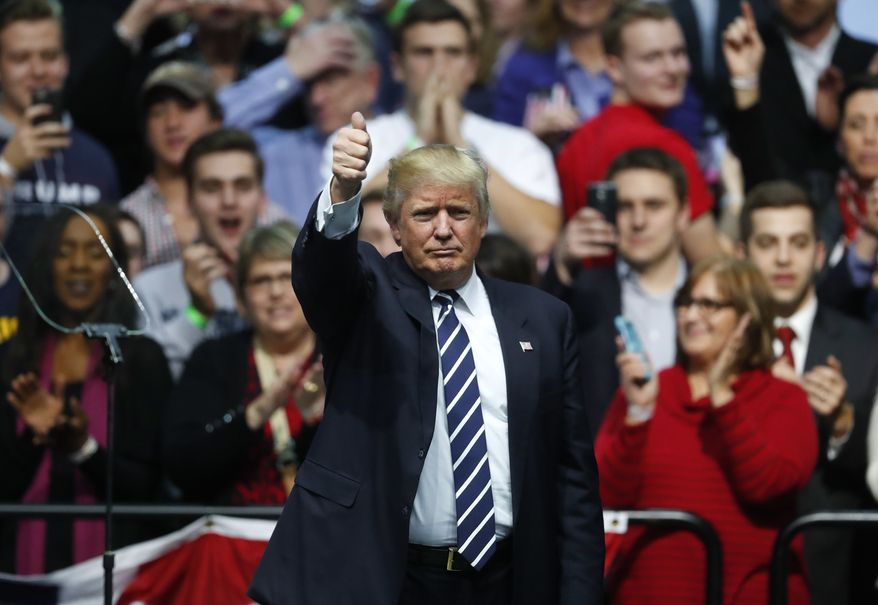 President-elect Donald Trump gives a thumbs up to supporters during a rally in Grand Rapids, Mich., Friday, Dec. 9, 2016. (AP Photo/Paul Sancya)