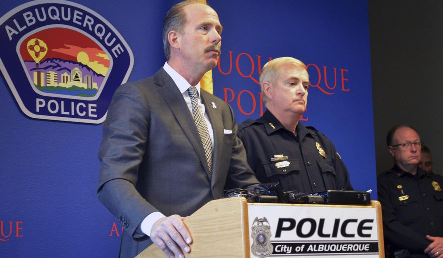 In this Tuesday, Dec. 6, 2016 photo, Albuquerque Mayor Richard Berry, left, and Police Chief Gorden Eden, right, speak at a press conference in Albuquerque, N.M. The U.S. Attorney's Office said Thursday the U.S. Department of Justice is investigating whether Albuquerque police lapel camera videos have been altered or deleted. (AP Photo/Russell Contreras)