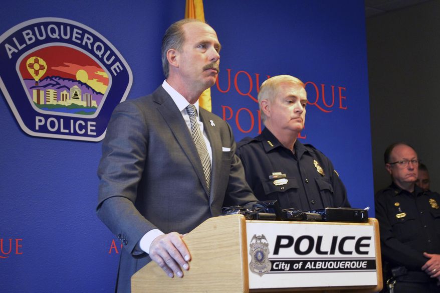 In this Tuesday, Dec. 6, 2016 photo, Albuquerque Mayor Richard Berry, left, and Police Chief Gorden Eden, right, speak at a press conference in Albuquerque, N.M. The U.S. Attorney's Office said Thursday the U.S. Department of Justice is investigating whether Albuquerque police lapel camera videos have been altered or deleted. (AP Photo/Russell Contreras)