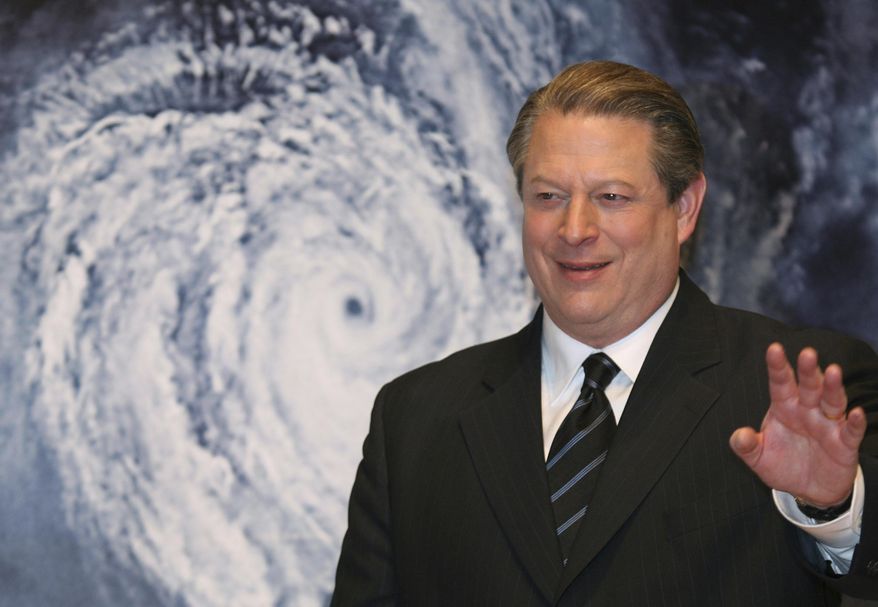 In this Jan. 15, 2007, file photo, former Vice President Al Gore acknowledges spectators in front of a poster of his starring documentary film "An Inconvenient Truth" on global warming before its screening during the Japan Premier at a theater in Tokyo. (AP Photo/Koji Sasahara, File)