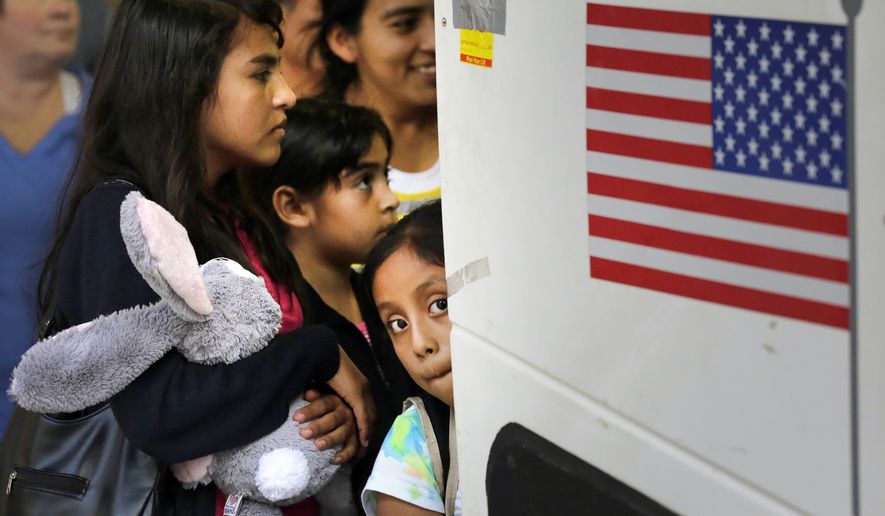 Immigrants from El Salvador and Guatemala who entered the country illegally board a bus after they were released from a family detention center in San Antonio, Texas. (Associated Press)