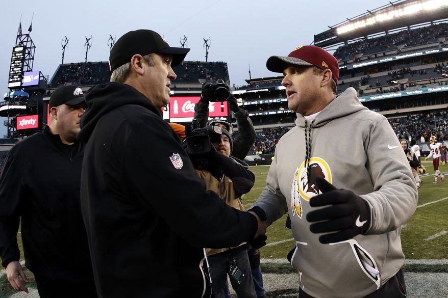 Washington Redskins head coach Jay Gruden right, and Philadelphia Eagles head coach Doug Pederson meet after an NFL football game, Sunday, Dec. 11, 2016, in Philadelphia. (AP Photo/Michael Perez)