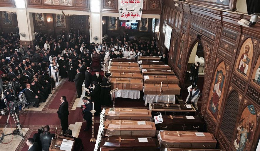 The spiritual leader of Egypt's Orthodox Christians, Pope Tawadros II, center, leads the funeral service for victims of a Sunday cathedral bombing, at the Virgin Mary Church, in Cairo, Egypt, Monday, Dec. 12, 2016. Egyptians held prayers for 25 Christians killed the day before at a church next to the city's main Coptic cathedral in what was one of the deadliest attacks on the religious minority in recent memory. The bomb went off while worshippers were attending Sunday Mass at a chapel adjacent to St. Mark's Cathedral. The coffins of the 25 have been laid in front of the altar, with the names of each victim plastered on the side facing the congregation. (AP Photo/Nariman El-Mofty)