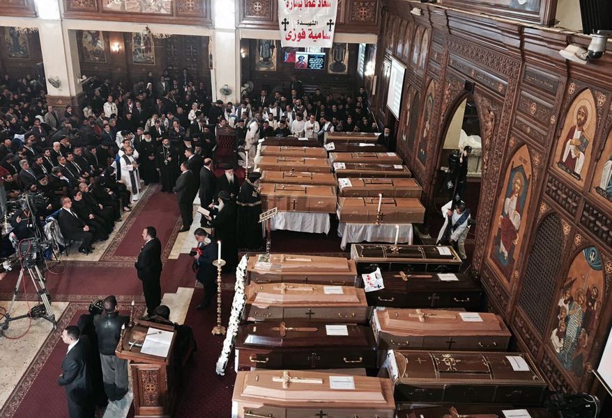 The spiritual leader of Egypt's Orthodox Christians, Pope Tawadros II, center, leads the funeral service for victims of a Sunday cathedral bombing, at the Virgin Mary Church, in Cairo, Egypt, Monday, Dec. 12, 2016. Egyptians held prayers for 25 Christians killed the day before at a church next to the city's main Coptic cathedral in what was one of the deadliest attacks on the religious minority in recent memory. The bomb went off while worshippers were attending Sunday Mass at a chapel adjacent to St. Mark's Cathedral. The coffins of the 25 have been laid in front of the altar, with the names of each victim plastered on the side facing the congregation. (AP Photo/Nariman El-Mofty)