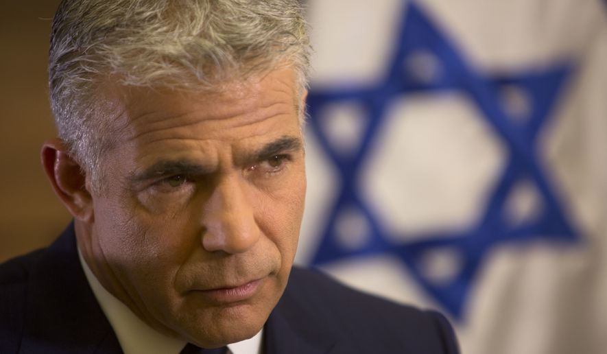 File - In this Monday, Oct. 31, 2016 file photo, Israeli Knesset member, Yair Lapid, leader of the Yesh Atid party, gives an interview to The Associated Press, in his office at the Knesset, Israel&#39;s parliament, in Jerusalem. Lapid, leading Israeli opposition politician is questioning Prime Minister Benjamin Netanyahu&#39;s goal of dismantling the international community&#39;s nuclear deal with Iran. Lapid told foreign reporters Monday that while he also does not like the deal, it may be too late to stop it. (AP Photo/Sebastian Scheiner, file)