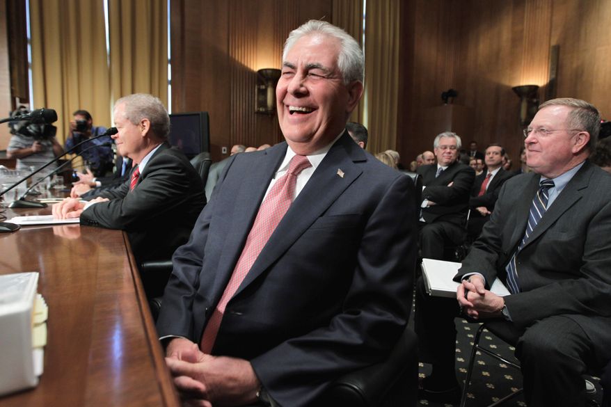 LED IN: ExxonMobil chairman and CEO Rex Tillerson laughs as he takes his seat on Capitol Hill in Washington, Thursday, May 12, 2011, prior to testifying before the Senate Finance Committee hearing with top executives from the big oil companies on high gasoline prices and high profits. (AP Photo/J. Scott Applewhite) (Associated Press photographs)