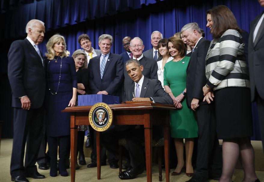President Barack Obama signs the 21st Century Cures Act, Tuesday, Dec. 13, 2016, in the South Court Auditorium in the Eisenhower Executive Office Building on the White House complex in Washington. (AP Photo/Pablo Martinez Monsivais)