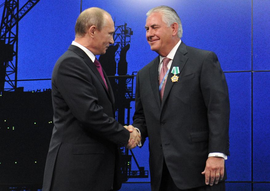 In this photo taken Thursday, June 21, 2012, Russian President Vladimir Putin presents ExxonMobil CEO Rex Tillerson with a Russian medal at an award ceremony of heads and employees of energy companies at the St. Petersburg economic forum in St. Petersburg, Russia. An aide to President Vladimir Putin praised United States President-elect Donald Trump’s choice of Rex Tillerson to lead the State Department and says that the businessman is well regarded by many Russian officials. (Mikhail Klimentyev/Sputnik, Kremlin Pool Photo via AP)
