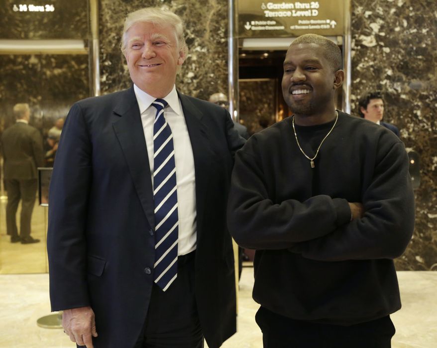 President-elect Donald Trump and Kanye West pose for a picture in the lobby of Trump Tower in New York, Tuesday, Dec. 13, 2016. (AP Photo/Seth Wenig)