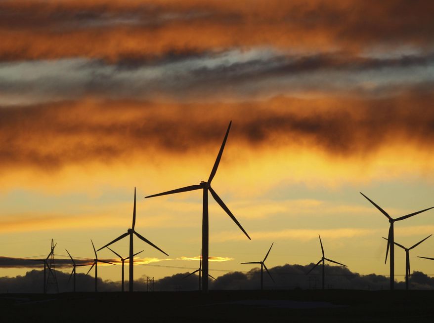 CORRECTS LOCATION FROM EAST TO WEST - FILE - In this Jan. 19, 2010 photo, clouds turn orange and purple as the sun sets behind the Happy Jack Wind Farm west of Cheyenne, Wyo. Two power line projects that won federal approval Tuesday, Dec. 13, 2016, will give a big capacity boost to the Western energy grid, including voltage from potentially the biggest wind farm in the U.S--Anschutz Corporation's Chokecherry-Sierra Madre wind farm in southern Wyoming. The TransWest Express project will help California meet its renewable energy goals with wind power from Wyoming. (Michael Smith/The Wyoming Tribune Eagle via AP, file)