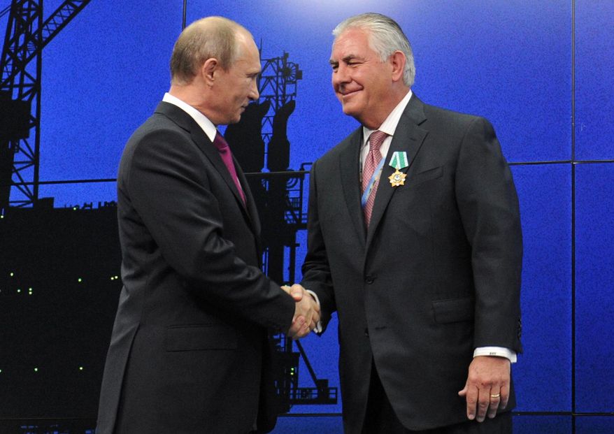 In this photo taken Thursday, June 21, 2012, Russian President Vladimir Putin presents ExxonMobil CEO Rex Tillerson with a Russian medal at an award ceremony of heads and employees of energy companies at the St. Petersburg economic forum in St. Petersburg, Russia. An aide to President Vladimir Putin praised United States President-elect Donald Trump’s choice of Rex Tillerson to lead the State Department and says that the businessman is well regarded by many Russian officials. (Mikhail Klimentyev/Sputnik, Kremlin Pool Photo via AP)