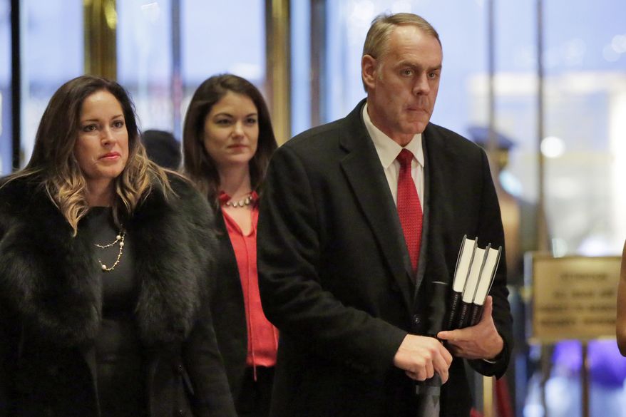 CORRECTS TO INTERIOR SECRETARY -FILE- In this Dec. 12, 2016, file photo, Rep. Ryan Zinke, right, R-Mont., President-elect Donald Trump's choice for interior secretary, arrives at Trump Tower, in New York. Conservatives who have long complained about the government’s control of vast Western lands hope they will have a new ally in Donald Trump, who has sent mixed signals about how he might manage land and whether he would relinquish federal authority over millions of acres. Zinke denies that he favors relinquishing federal control of the land, as Democrats allege. (AP Photo/Richard Drew, File)