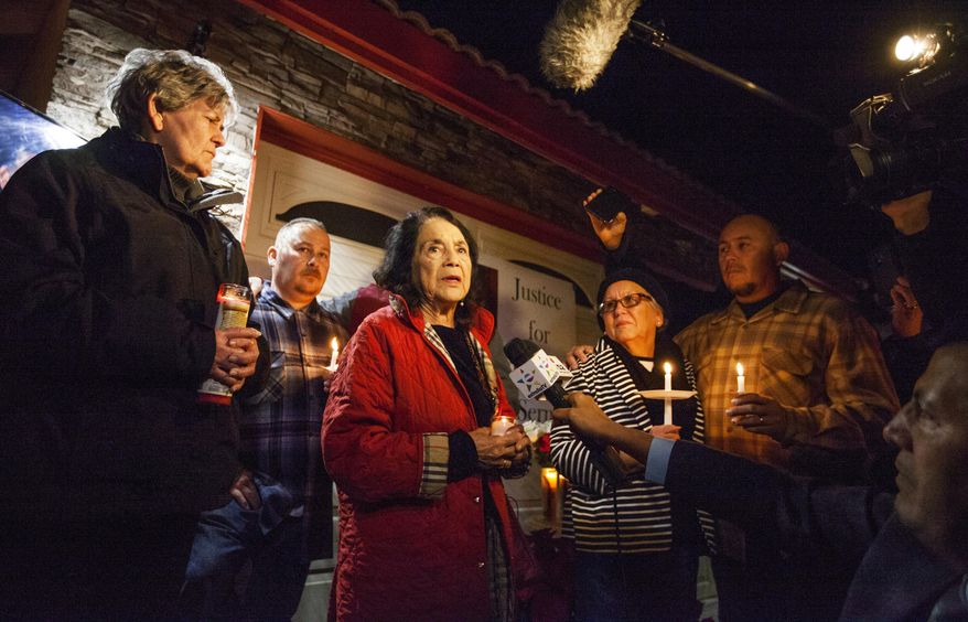 In this photo provided by The Bakersfield Californian, activist Dolores Huerta, center, speaks at a candlelight vigil for Francisco Serna, 73, Tuesday, Dec. 13, 2016, in Bakersfield, Calif. From right are Serna&#39;s son Frank Serna, wife Rubia Serna and son Roy Serna. Serna was shot and killed by a Bakersfield, Calif., police officer near his home early Monday. Police Chief Lyle Martin said Tuesday that the unarmed Serna refused to take his hand out of his pocket when he was shot by an officer who thought he had a gun. Serna&#39;s family said he suffers from dementia and he often took walks in the evening. (Felix Adamo/The Bakersfield Californian via AP)