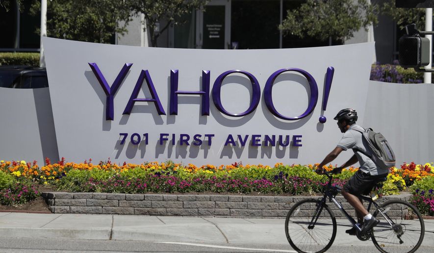 FILE - In this Tuesday, July 19, 2016 file photo, a cyclist rides past a Yahoo sign at the company&#39;s headquarters in Sunnyvale, Calif. (AP Photo/Marcio Jose Sanchez)
