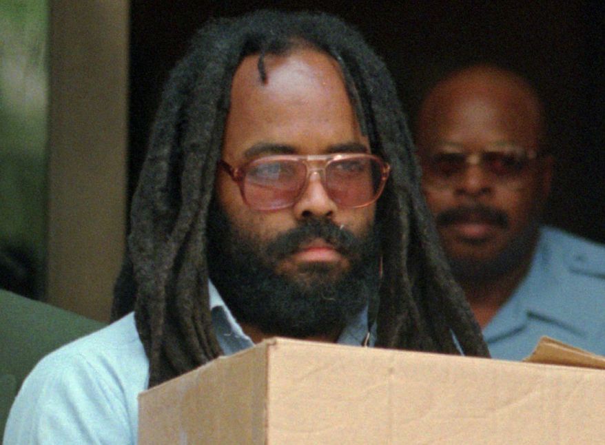 Mumia Abu-Jamal leaves Philadelphia&#x27;s City Hall after a hearing on July 12, 1995. Abu-Jamal is serving a life term for the 1981 killing of a Philadelphia police officer. (Associated Press)