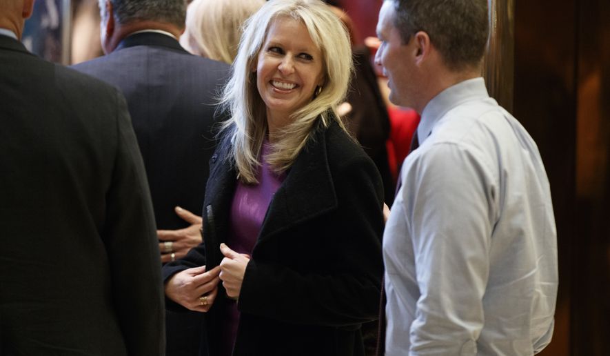 Monica Crowley smiles as she exits the elevator in the lobby of Trump Tower in New York, Thursday, Dec. 15, 2016. (AP Photo/Evan Vucci)
