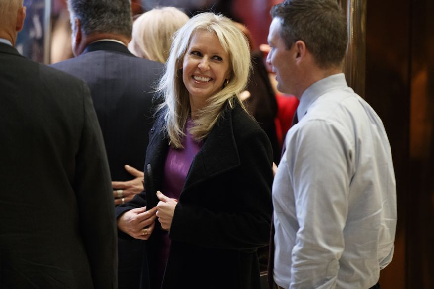 Monica Crowley smiles as she exits the elevator in the lobby of Trump Tower in New York, Thursday, Dec. 15, 2016. (AP Photo/Evan Vucci)