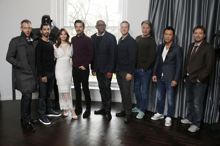 Actors from left, Ben Mendelsohn, Riz Ahmed, Felicity Jones, Diego Luna, Forest Whitaker, Alan Tudyk, Mads Mikkelsen, Donnie Yen and director Gareth Edwards pose for photographers during the Rogue One: A Star Wars Story fan photo call in London, Wednesday, Dec. 14, 2016. (Photo by Joel Ryan/Invision/AP)