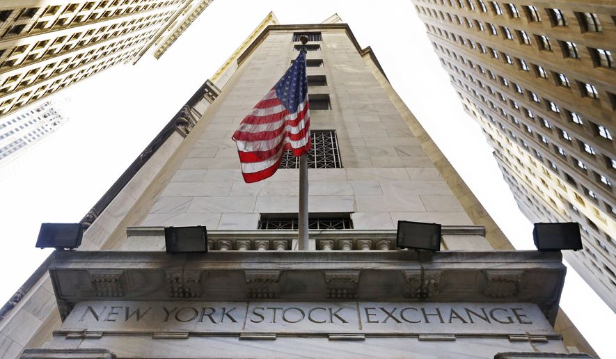 In this Friday, Nov. 13, 2015, file photo, the American flag flies above the Wall Street entrance to the New York Stock Exchange. (AP Photo/Richard Drew, File)