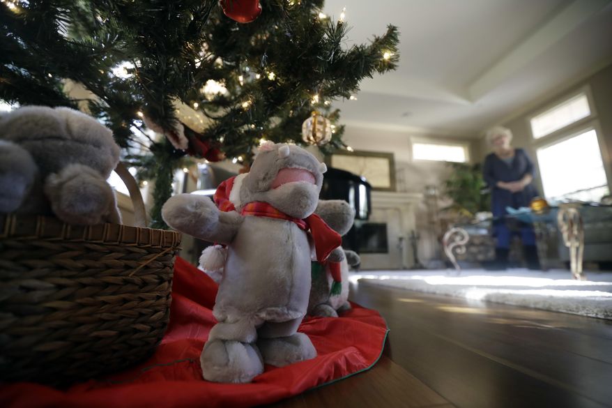 Gayla Peevey, singer of that enduring Christmas classic, "I Want a Hippopotamus For Christmas," stands behind stuffed animal hippopotamuses under her Christmas tree in her home Wednesday, Dec. 14, 2016, in La Mesa, Calif. It was 1953, and one of the hottest songs on the radio was “I Want a Hippopotamus For Christmas.” Now it’s Christmas 2016, and Peevey is still singing. She leaves that to schoolchildren, ringtones, iTunes downloads and TV commercials that, to the 73-year-old singer’s amazement, keep the song in everyone’s head every Christmas season, whether they want it there or not. (AP Photo/Gregory Bull)