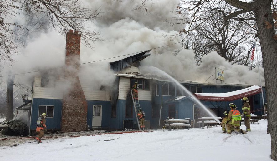 Firefighters from Indiana and Michigan departments battle a fire at the Lake George Retreat restaurant on Lake George, just south of the Indiana-Michigan border Friday, Dec. 16, 2016. (Mike Marturello/The Herald Republican via AP)