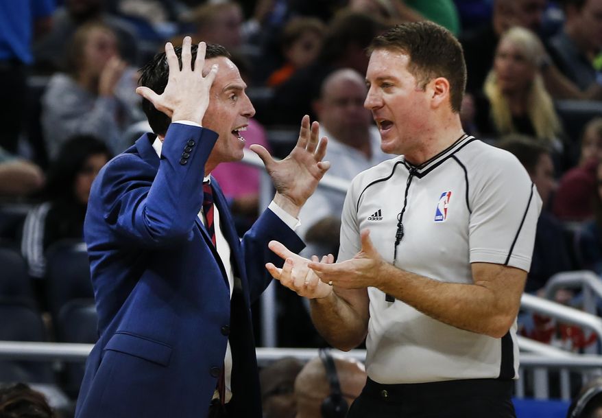 Brooklyn Nets head coach Kenny Atkinson, left, yells at referee Kevin Cutler during the first half of an NBA basketball game in Orlando, Fla., on Friday, Dec. 16, 2016. (AP Photo/Reinhold Matay)