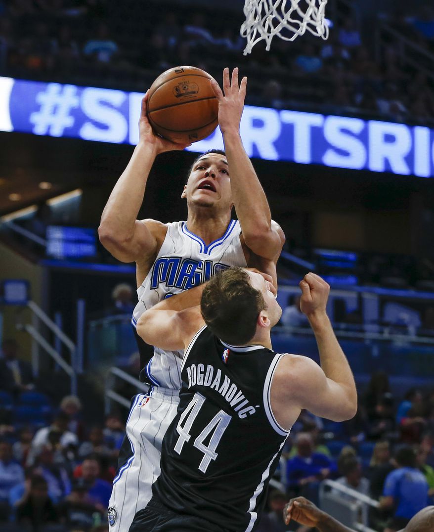 Orlando Magic forward Aaron Gordon (00) shoots over Brooklyn Nets guard Bojan Bogdanovic (44) during the first half of an NBA basketball game in Orlando, Fla., on Friday, Dec. 16, 2016. (AP Photo/Reinhold Matay)