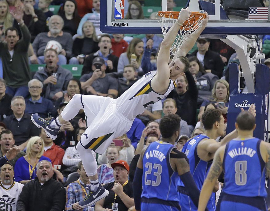 Utah Jazz forward Gordon Hayward, above dunks the ball on Dallas Mavericks' Wesley Matthews (23), Dwight Powell, center, and Deron Williams (8) argue with a referee in the first half during an NBA basketball game Friday, Dec. 16, 2016, in Salt Lake City. (AP Photo/Rick Bowmer)