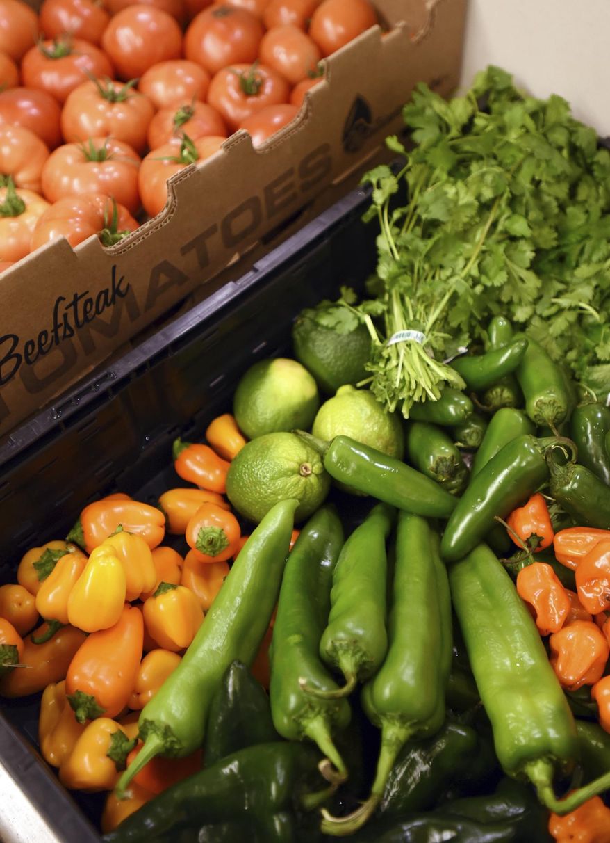 ADVANCE FOR THE WEKEND OF DEC. 17-18 AND THEREAFTER - In a Dec. 9, 2016 photo, fresh vegetables are laid out and ready to be chopped and prepped by Daniel Erickson, in the commercial kitchen at Sykes' in Kalispell, Mont. The fresh ingredients go into his Blaine Mountain Salsa which is available for sale in the Sykes' grocery store. Sykes' has turned its deli and meat shop area into commercial kitchen for local food processors like Dix and Daniel Erickson. (Brenda Ahearn/Daily Inter Lake via AP)