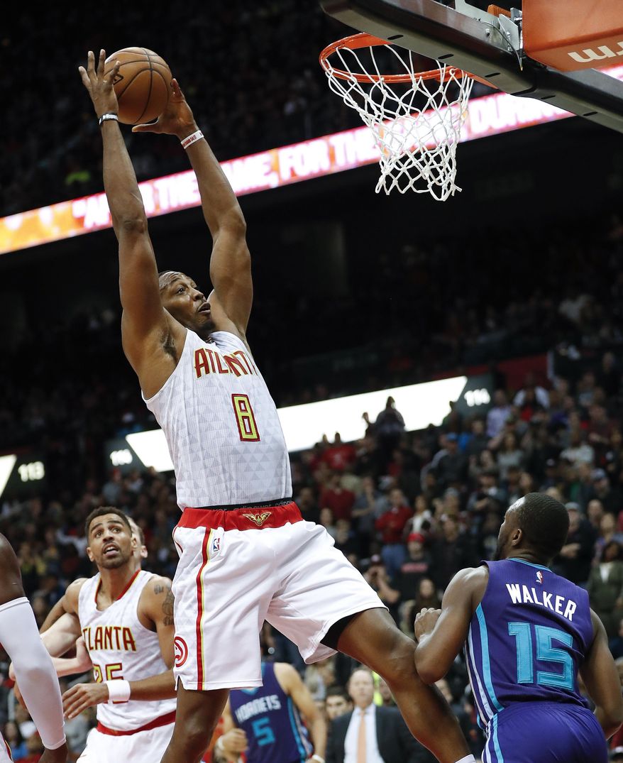 Atlanta Hawks center Dwight Howard (8) grabs a rebound against Charlotte Hornets guard Kemba Walker (15) in the second half of an NBA basketball game Saturday, Dec. 17, 2016, in Atlanta. Charlotte won 107-99. (AP Photo/John Bazemore)