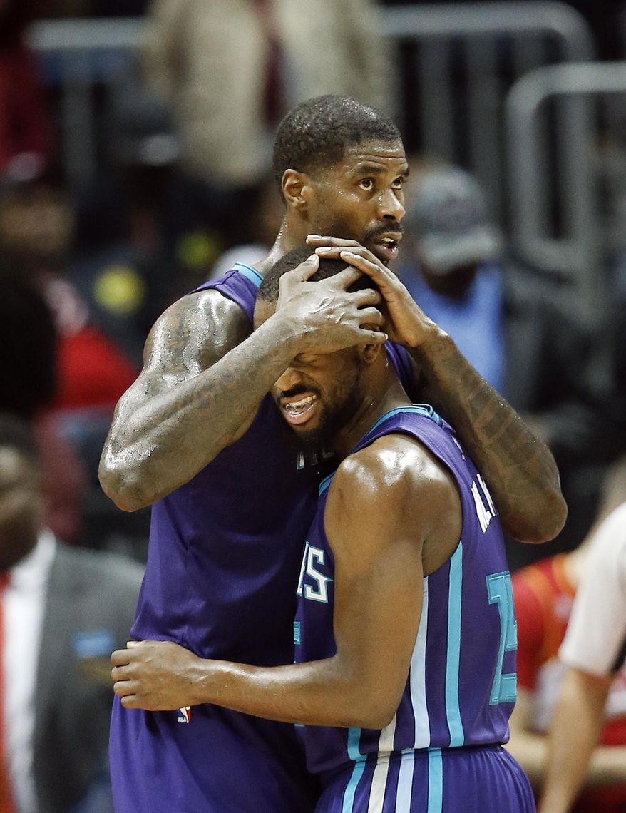 Charlotte Hornets' Marvin Williams (2) and Kemba Walker (15) embrace after defeating Atlanta Hawks in an NBA basketball game Saturday, Dec. 17, 2016, in Atlanta. Charlotte won 107-99. (AP Photo/John Bazemore)