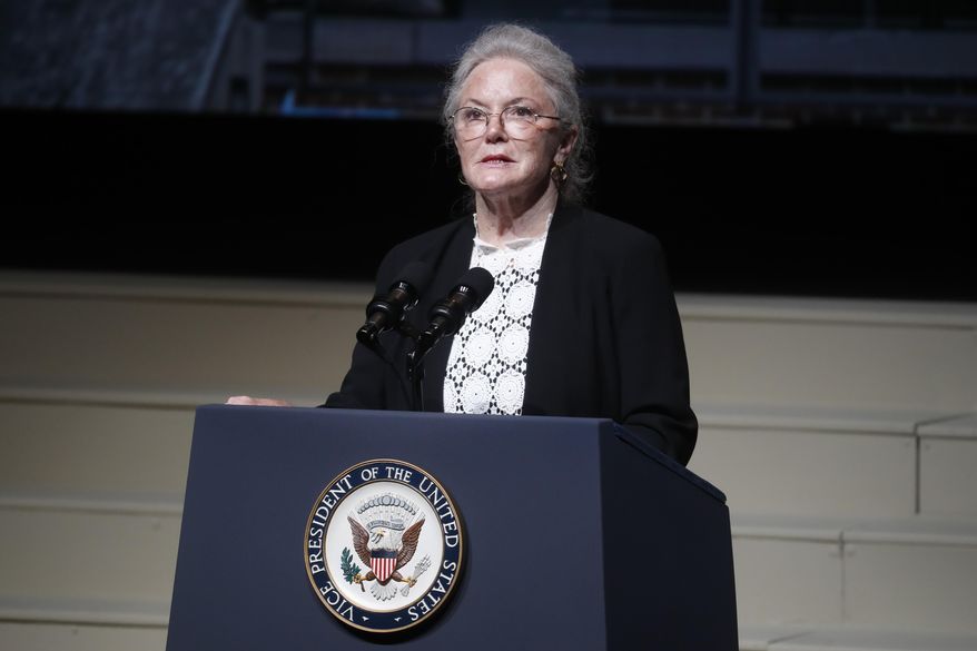 Carolyn Ann Glenn says goodbye to her father, John Glenn, as she finishes reading a letter she placed in his casket at the funeral of John Glenn at The Ohio State University, Saturday, Dec. 17, 2016, in Columbus, Ohio. Glenn, the famed astronaut, died Dec. 8 at age 95. (AP Photo/John Minchillo)