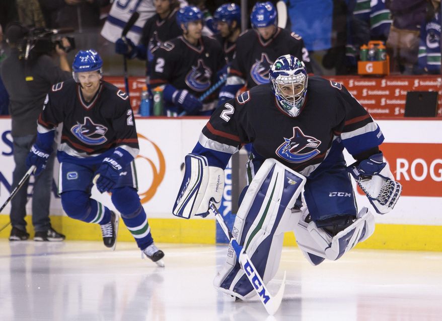 Vancouver Canucks' goaltender Ryan Miller (30) wears a jersey honoring former Vancouver Canuck Mattias Ohlund during warm-up prior to an NHL hockey game, Friday, Dec. 16, 2016 in Vancouver, British Columbia. (Ben Nelms/The Canadian Press via AP)