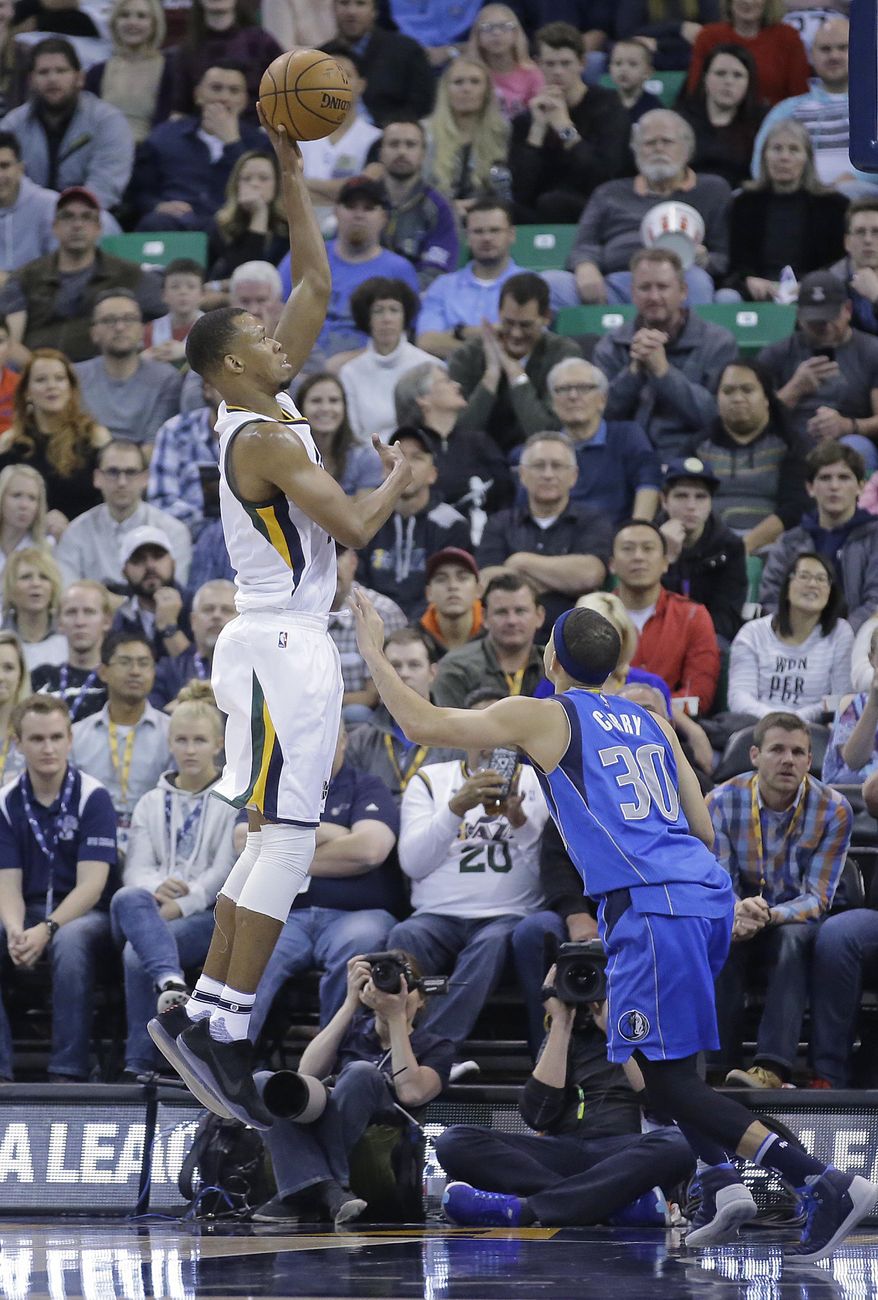 Utah Jazz guard Rodney Hood, left, shoots as Dallas Mavericks guard Seth Curry (30) defends in the first half during an NBA basketball game Friday, Dec. 16, 2016, in Salt Lake City. (AP Photo/Rick Bowmer)