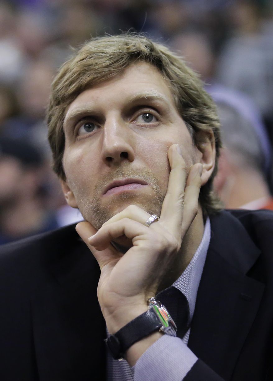 Dallas Mavericks forward Dirk Nowitzki sits on the bench in the first half during an NBA basketball game against the Utah Jazz, Friday, Dec. 16, 2016, in Salt Lake City. (AP Photo/Rick Bowmer)