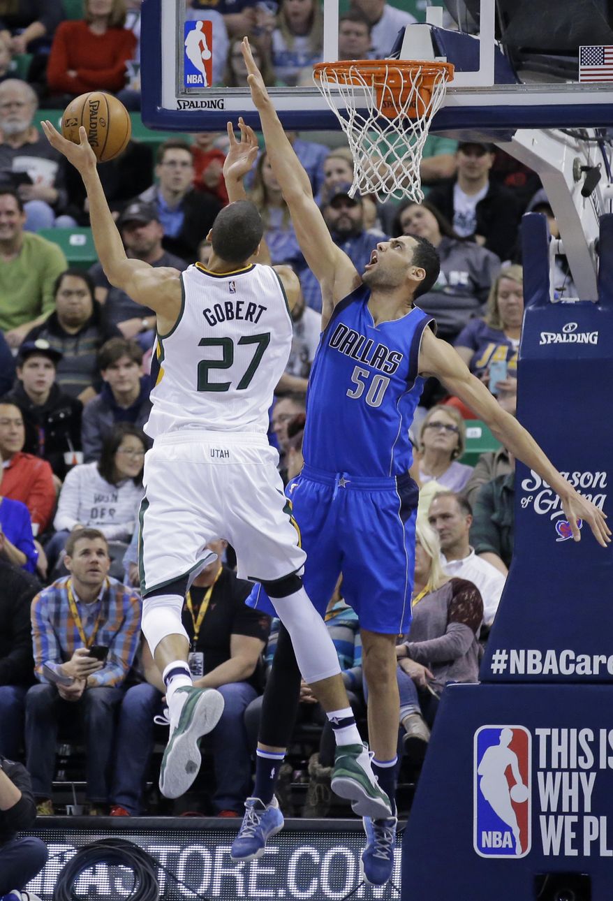 Utah Jazz center Rudy Gobert (27) shoots as Dallas Mavericks center Salah Mejri (50) defends in the first half during an NBA basketball game Friday, Dec. 16, 2016, in Salt Lake City. (AP Photo/Rick Bowmer)