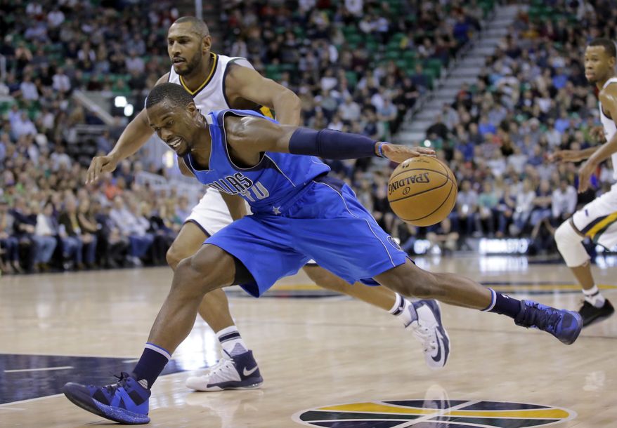 Dallas Mavericks forward Harrison Barnes (40) drives around Utah Jazz center Boris Diaw, rear, in the first half during an NBA basketball game Friday, Dec. 16, 2016, in Salt Lake City. (AP Photo/Rick Bowmer)