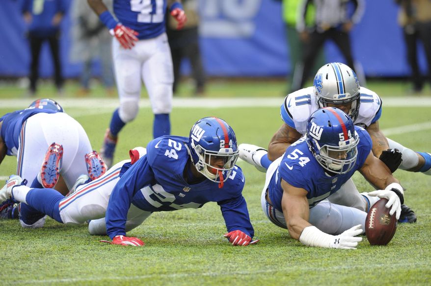 New York Giants defensive end Olivier Vernon (54) recovers a fumble as Detroit Lions wide receiver Marvin Jones (11) and Eli Apple (24) close in during the first half of an NFL football game Sunday, Dec. 18, 2016, in East Rutherford, N.J. (AP Photo/Bill Kostroun)